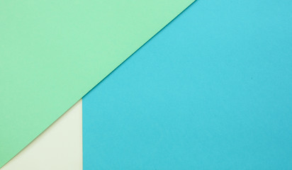 Multicolor paper background of treny mint, blue and white colors