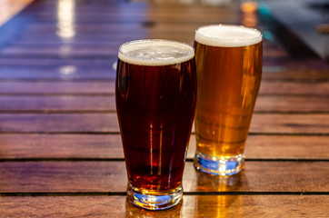 Two pints of beer on a wooden table
