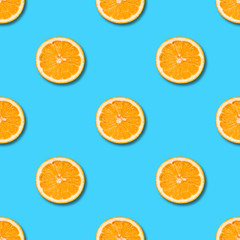 Seamless pattern with orange on blue background. Tropical abstract background.