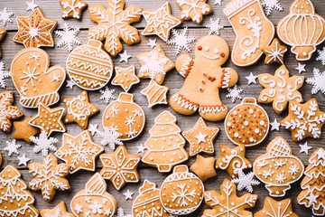 Christmas background, winter holidays, New Year party, celebration concept. Festive decorations, gift boxes and gingerbread on wooden background, greeting card template