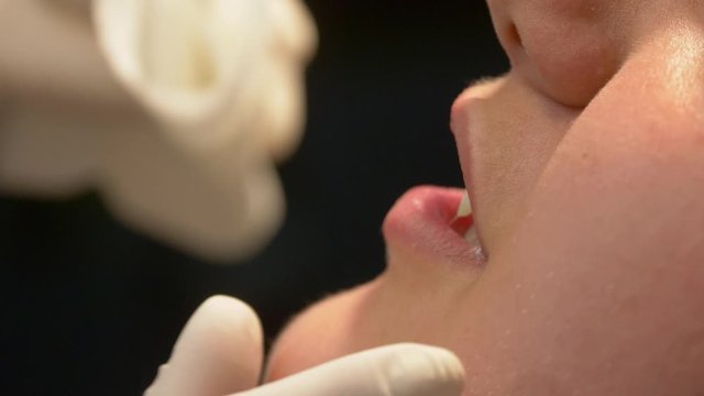 Preparation for a tongue piercing in a studio - close up shot