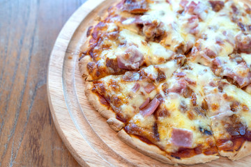 Hot pizza slice with dripping ham sausage and mozzarella cheese.