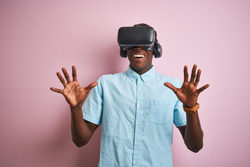 Young african american man playing virtual reality game using goggles