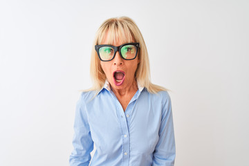 Middle age businesswoman wearing sunglasses and shirt over isolated white background scared in shock with a surprise face, afraid and excited with fear expression