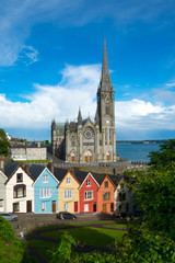 Fototapeta na wymiar Cobh Cathedral colored houses Landscape clear sky