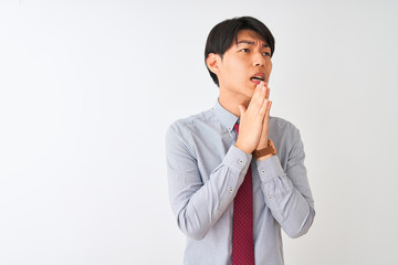 Chinese businessman wearing elegant tie standing over isolated white background begging and praying...