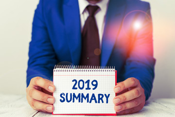 Word writing text 2019 Summary. Business photo showcasing brief comprehensive especially covering the main points of 2019 Man holds empty paper with copy space in front of him Space