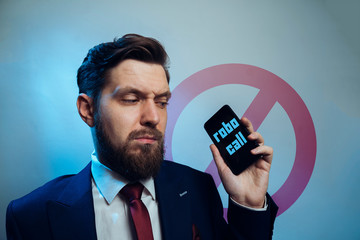Man frowning receiving telemarketing robo call 
