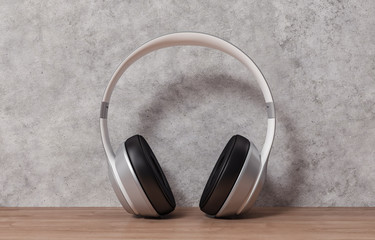 Headphones on wood table and cement background, 3d rendering