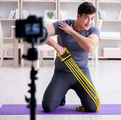 Naklejka na ściany i meble Sports and health blogger recording video in sport concept