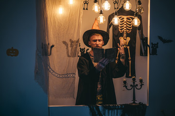 Halloween man with pumpkin in darkness. Halloween man with smile on dark background. Mystery and...