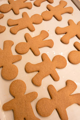 Gingerbread man cookies right out of the oven, freshly made at home, without decoration. Great for cooking with the kids as a family near the Christmas and winter holidays.