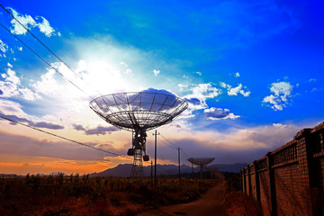 The silhouette of a radio telescope observatory