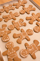Gingerbread man cookies freshly made at home, just decorated with white icing in a funny and happy style. Great for making with the kids as a family near the Christmas and winter holidays.