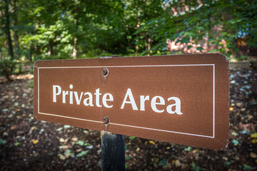Private Area sign warns visitors away from shady garden
