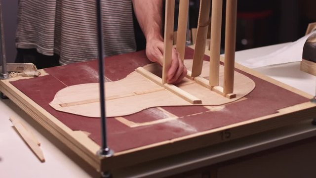Luthier makes handmade acoustic guitar