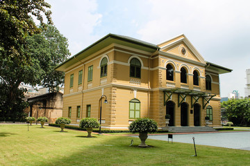 Landscape photo of Perspective view of The 1st old house on street in Bangkok Thailand, Heritage yellow house in European Neo classic style.