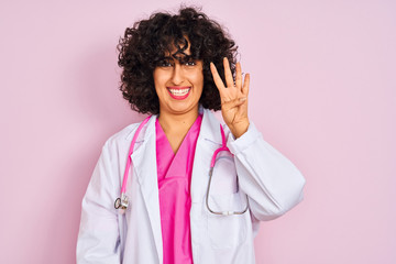 Young arab doctor woman with curly hair wearing stethoscope over isolated pink background showing and pointing up with fingers number four while smiling confident and happy.