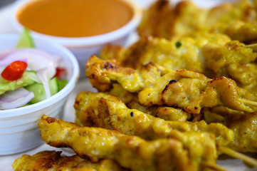 Grill pork satay (moo satay) with Thai Spices and Peanut Sauce Recipe, and pickled cucumbers, Onions in vinegar, Barbecue pork, Thai street food delicious, Popular Thai cuisine for tourists. Bangkok.