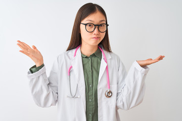 Young chinese dooctor woman wearing glasses stethoscope over isolated white background clueless and...