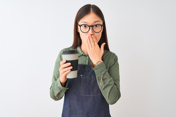 Chinese barista woman wearing apron glasses drinking coffee over isolated white background cover...