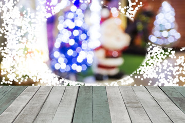 Obraz premium Spray snow through glass window background with wood table.