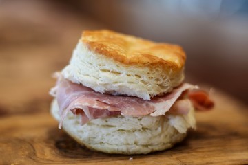 Closeup of a homemade buttermilk biscuit with country ham