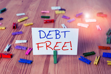 Text sign showing Debt Free. Business photo text does not owning any money to any individual or companies Colored clothespin papers empty reminder wooden floor background office
