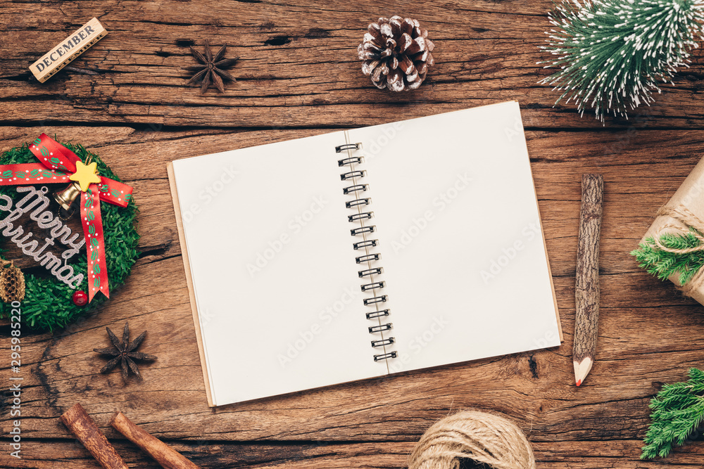 Aufkleber top view of blank notebook on grunge wood background with xmas decorations. mockup christmas backgro