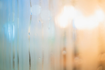 Drops of rain on window with abstract lights. Drops Of Rain On Blue Glass Background. Street Bokeh Lights Out Of Focus.