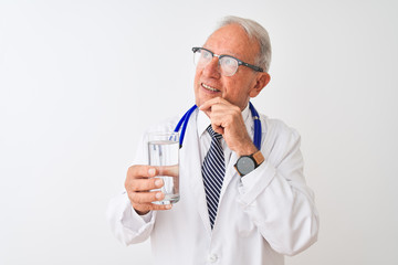 Senior grey-haired doctor man drinking glass of water over isolated white background serious face thinking about question, very confused idea