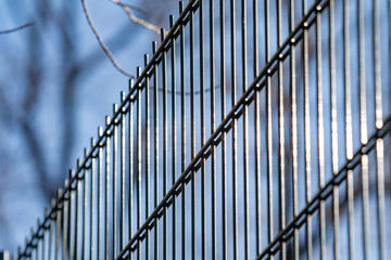 Metal grill against the blue sky.