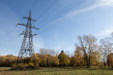 Power lines, insulators and wires. high voltage pylons against the blue sky and sunlight. High voltage tower or high voltage tower. Green energy concept, Power plant, Close up of high voltage