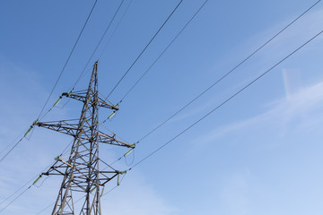 Power lines, insulators and wires. high voltage pylons against the blue sky and sunlight. High voltage tower or high voltage tower. Green energy concept, Power plant, Close up of high voltage