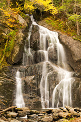 A waterfall in the fall full of fall or autumn colors in the forest