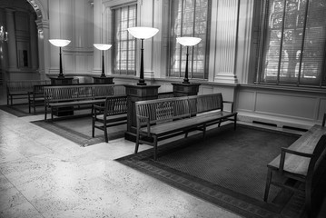 waiting room at the train station is empty in black and white