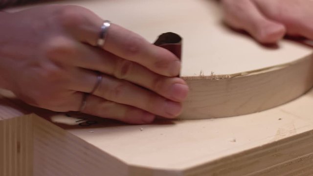 Guitar maker uses sandpaper on acoustic guitar sides