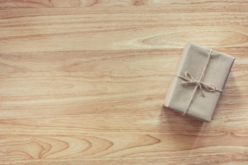 Brown gift box on wooden table background with copy space