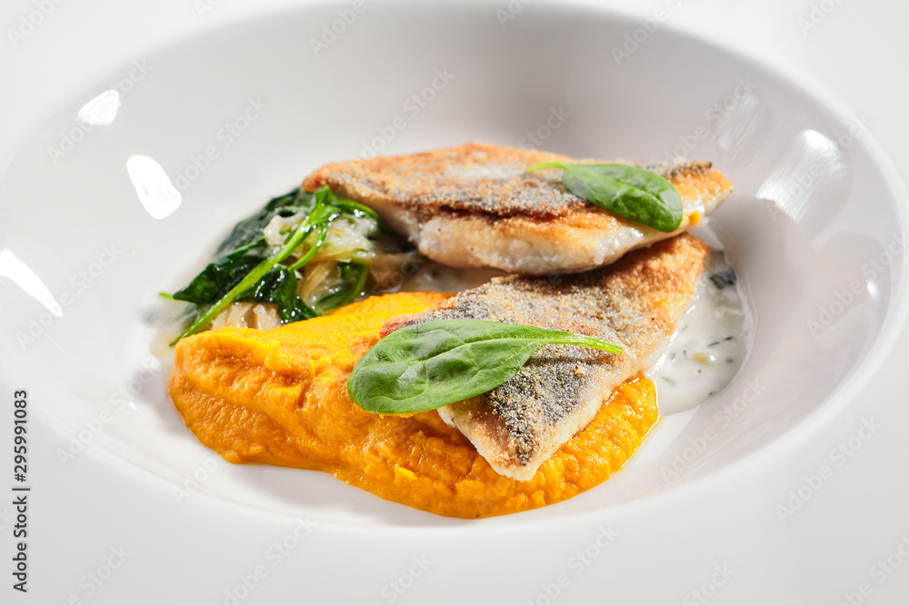 Wall mural cod fillet with pumpkin puree and spinach