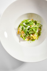 Tortellini with rabbit meat pesto sauce and arugula