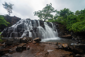 Fototapeta na wymiar Beautiful Savdav Waterfall seen during Monsoon months near Kankavli,Sindhudurga,Maharashtra,India