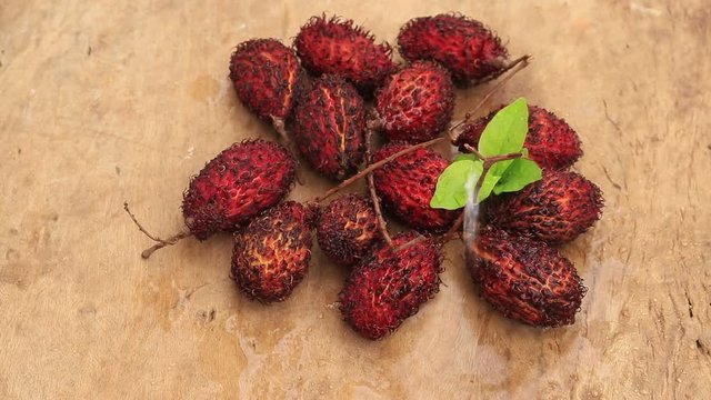 Lychee with leaves isolated on wood background.