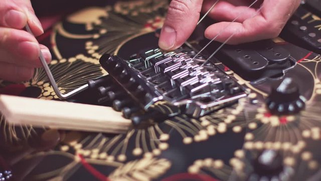 Luthier fix strings bridge on broken guitar