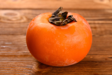 side view persimmon on a wooden table