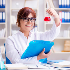 Female scientist researcher conducting an experiment in a labora