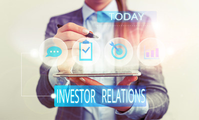 Handwriting text Investor Relations. Conceptual photo analysisagement responsibility that integrates finance Female human wear formal work suit presenting presentation use smart device