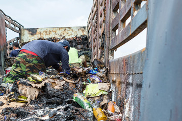 Poor people digging, searching and collecting rubbish for sale in Thailand.