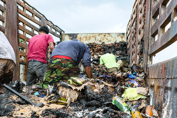 Poor people digging, searching and collecting rubbish for sale in Thailand.