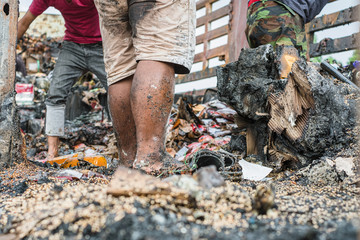 Poor people digging, searching and collecting rubbish for sale in Thailand.