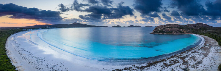 Aerial panorama at sunrise of the beautiful turquoise waters and beach at Lucky Bay, located near...